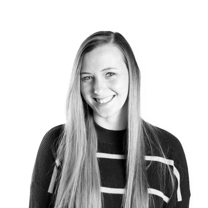 A vintage photo of a woman grinning, perfect for marketing experts.