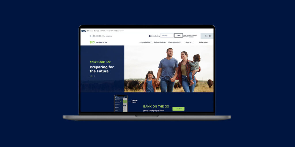 A laptop displays the TFNB banking website homepage, featuring a family of four walking outdoors, with sections about online banking and account management for 2025 visible on the screen.