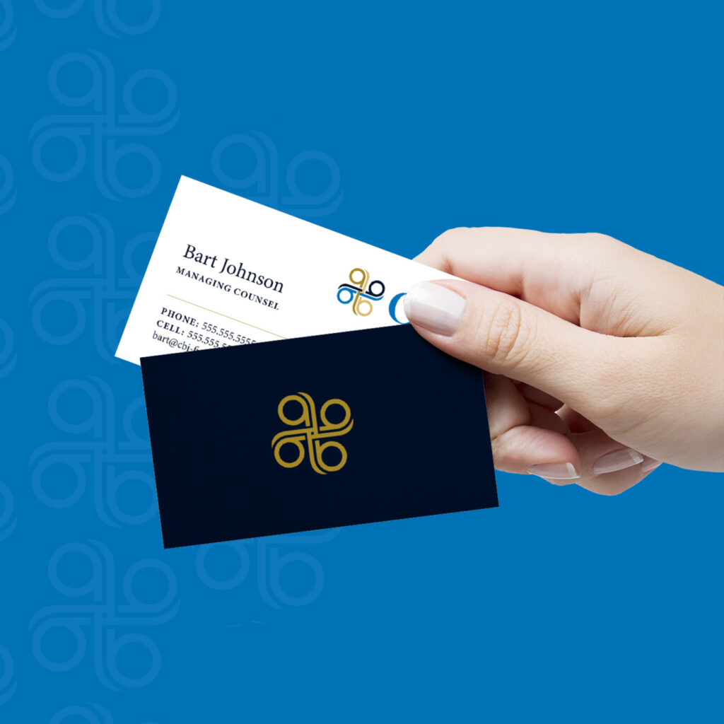A hand holds two business cards for CBJ Financial: one white card with contact info and a colored logo, and one dark card displaying only the logo, set against a blue background.