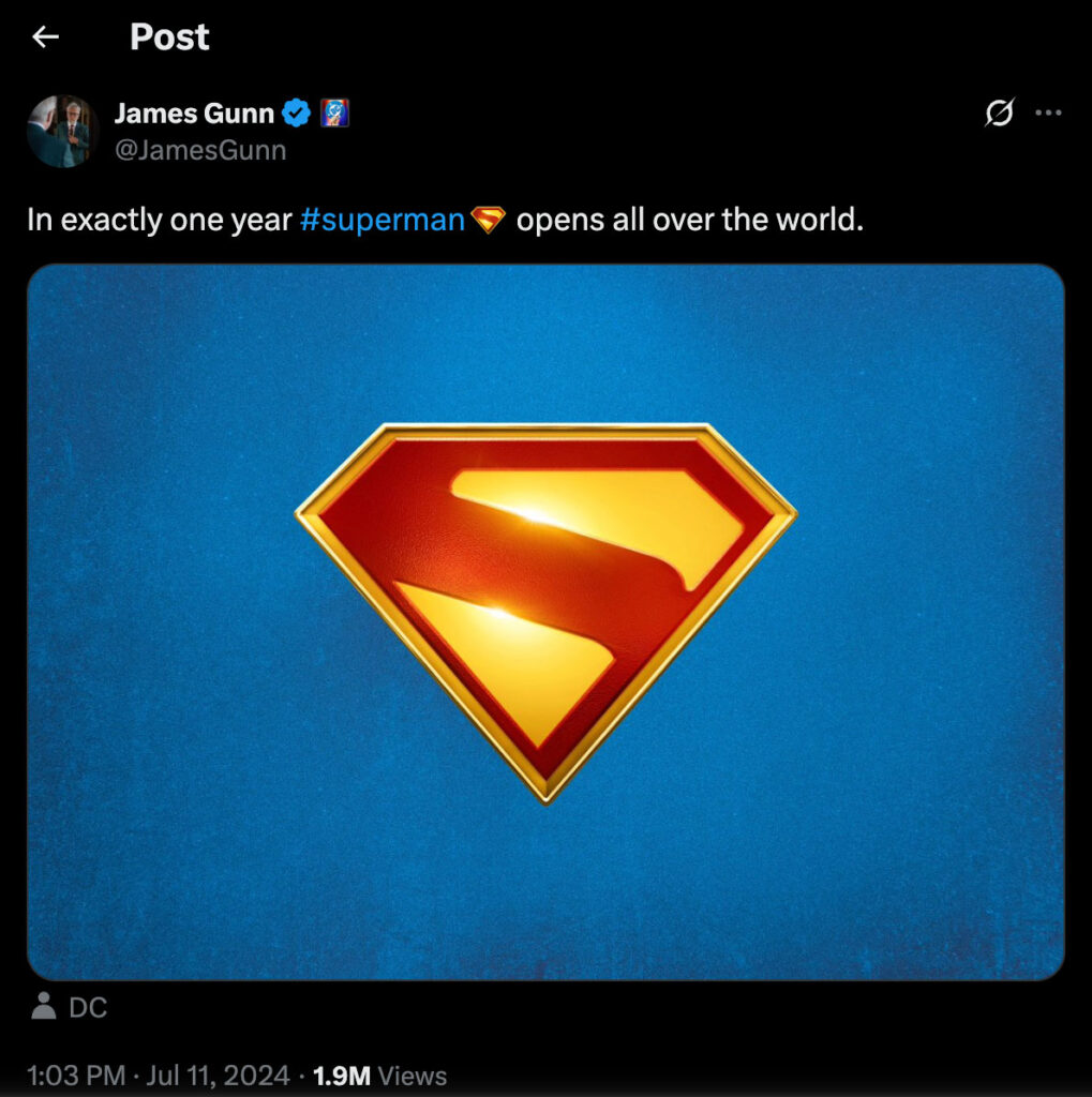 A yellow and red Superman Logo is centered on a blue background in a promotional image for the superhero movie "Superman.