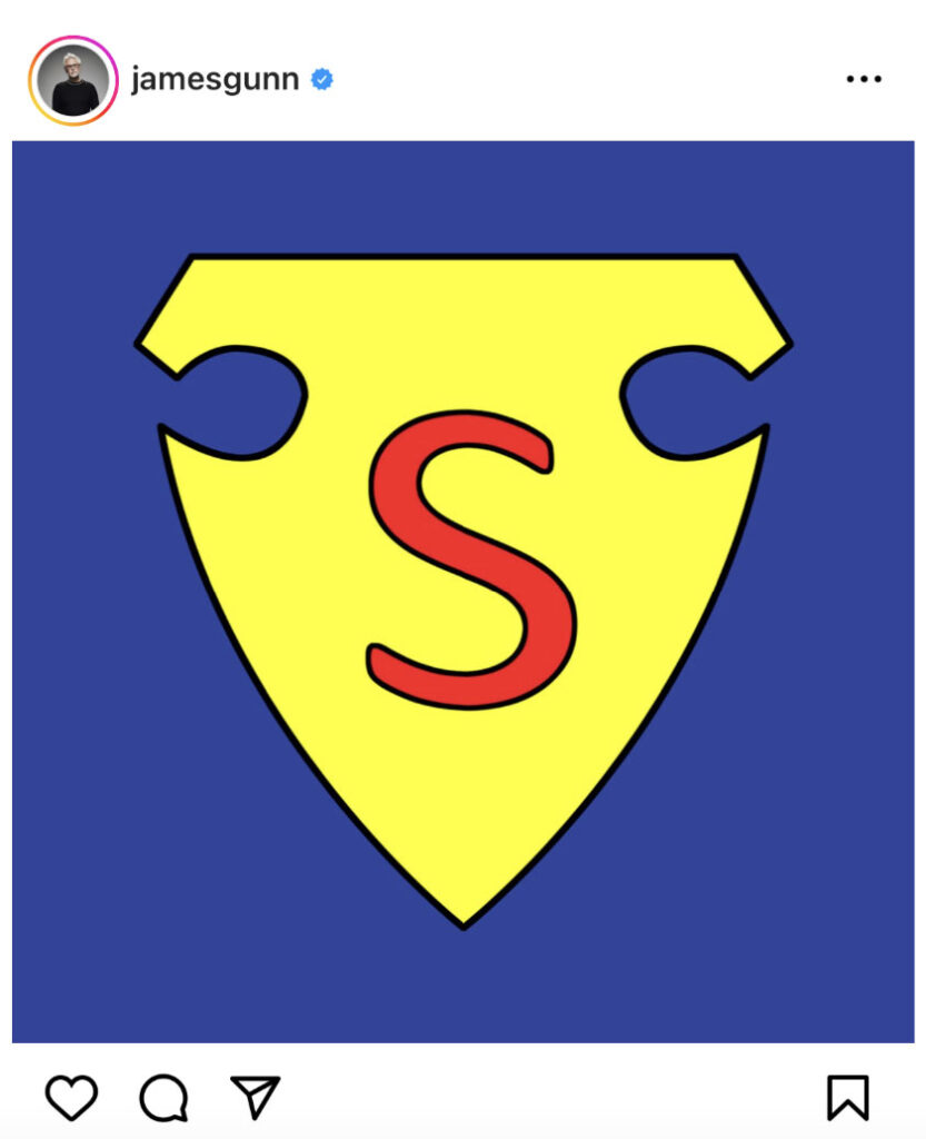 A stylized yellow shield with a red "S" and two cutouts on top, set against a blue background, resembling the iconic Superman Logo.