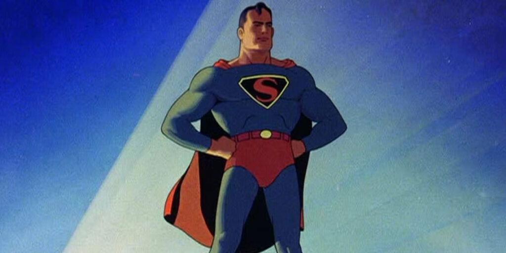Animated superhero in a blue and red costume with a cape stands confidently, hands on hips, against a blue background featuring the iconic Superman Logo.