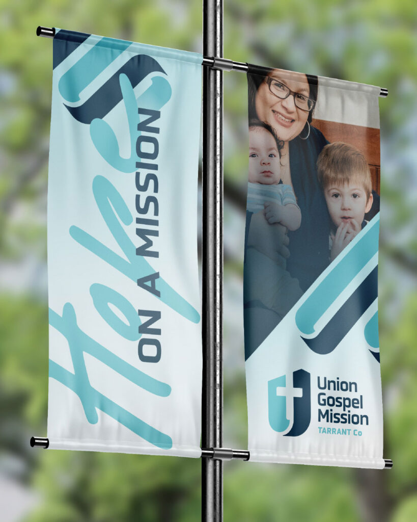 Two vertical banners on a pole; one reads "Hope on a Mission," and the other shows a woman with two children and the "Union Gospel Mission Tarrant Co" logo.